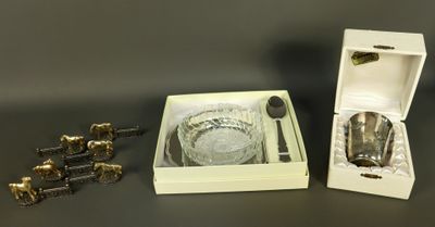 a glass bowl and spoon in a box with a spoon and spoon rest