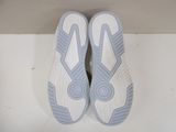 pair of white and blue tennis shoes on a white surface