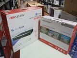 Deux cartons contenant des produits Hikvision sont posés sur une table dans un magasin.