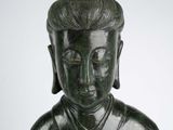 statue of a man with a hat on his head and a flower in his hand