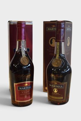 two bottles of wine sitting next to each other in front of a box