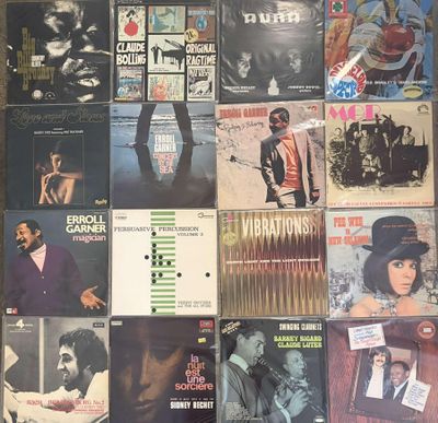several records are stacked on top of each other on a table