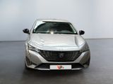 the front view of a silver car parked in a showroom