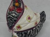 a chicken that is sitting on a white table