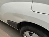 a close up of a car ' s tire on the side of the road