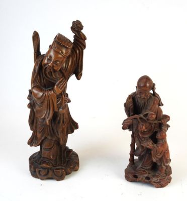 pair of chinese carved wood figurines of a man and a woman