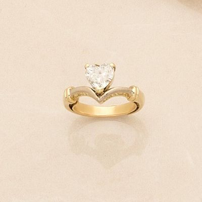 a gold ring with a heart shaped diamond on it
