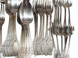 a lot of silver spoons and spoon spoons on the table