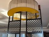 a large lamp that is hanging from the ceiling in a restaurant