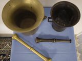two old brass items on a blue table