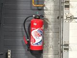 a fire extinguisor attached to the side of a building