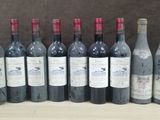 several bottles of wine are lined up on a table