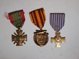 three medals are sitting on a table next to each other