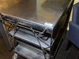 a metal table with a metal shelf on top of it