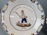 a plate with a picture of a man holding a baseball bat