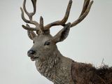 a statue of a deer with antlers on it ' s head