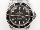 an image of a rolex watch with a black dial and gold hands