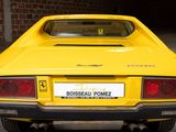 a yellow car that is parked in a garage