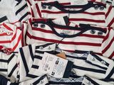 a lot of shirts that are sitting on a table