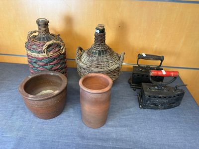 three vases sitting on a table next to an old typewriter