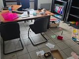 a messy office with a lot of clutter on the floor