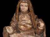 statue of a woman sitting on a rock holding a baby