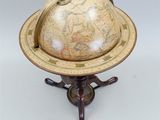 an old globe on a stand with a metal handle