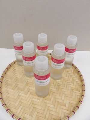 bottles of lotion sitting on top of a bamboo tray on a table