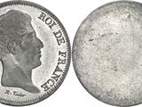 a close up of a coin with a man ' s face on it