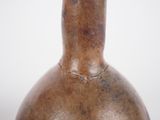 a brown vase that has a brown handle on it