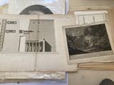 a lot of old black and white photos on a table