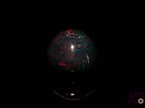 an image of a black oplite with red and green speckles