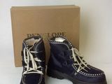 navy blue boots with white laces and a box on a white surface