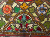 an image of a close up of a stained glass window with flowers