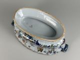 a white bowl with blue flowers on it on a table