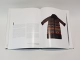 an open book with a picture of a coat on it