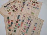 several old stamps are stacked on top of each other on a table