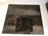 a black stove top with four burners on it