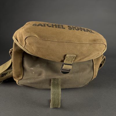 the back of a tan bag with a black logo on it