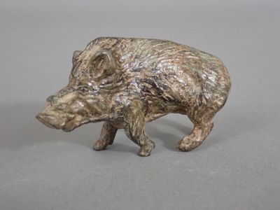 a small figurine of a boar on a table
