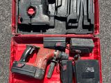 a red tool case with tools in it on the ground