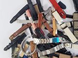 a pile of assorted watches on a white surface