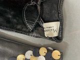 a black purse with a gold and silver coin inside of it