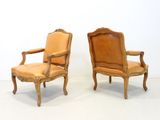 pair of french louis xv style carved wood armchairs with leather upholstered seats