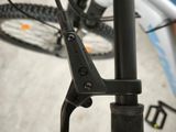 a close up of a bike handle with a bike in the background