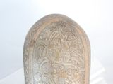 a vase that has a design on it on display