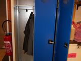 a blue locker in the corner of a room