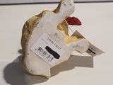 a small figurine of a bird with a tag on it ' s neck