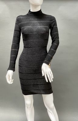 a mannequin wearing a black and white striped dress