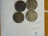 three coins sitting on top of a piece of paper on a table